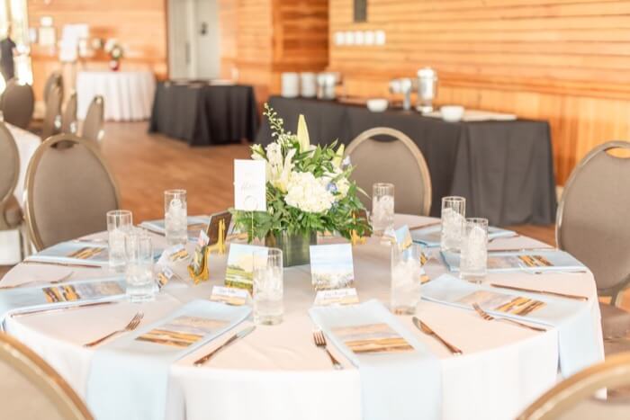 Tables with blue napkins and paintings