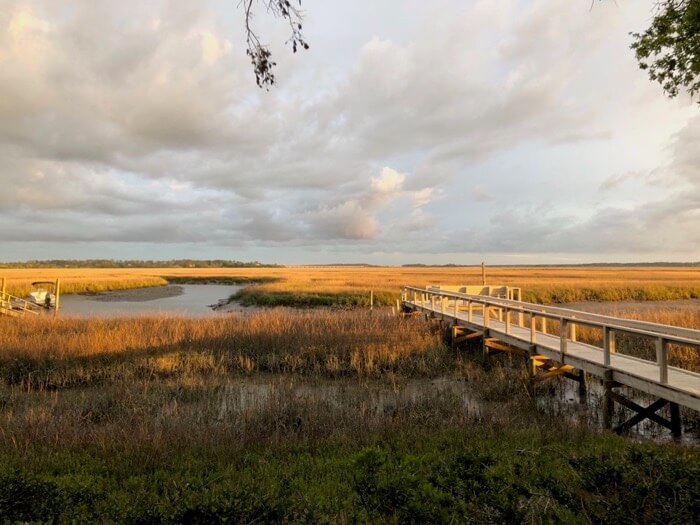 Old dock with sun setting on the marsh photo by Kathy Miller